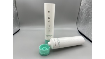 white lotion tube with green flip cap 