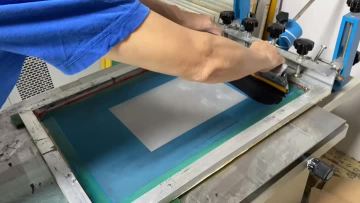 The screen printing of water based ink on glass