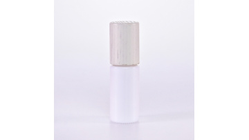 White glass roll on bottle with wooden lid