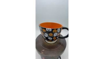 Halloween pumpkin lantern through cup