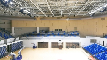What are the advantages of fabric air ducts in gymnasiums