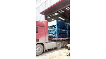 The entire batching plant is being loaded onto trucks.