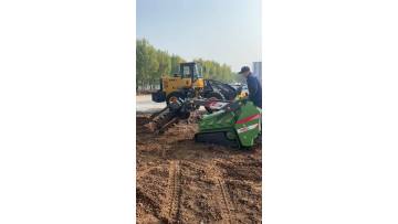 Three-cylinder skid steer loader trencher in operation