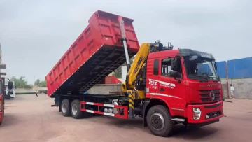 Rear double axle dump truck with accompanying cran
