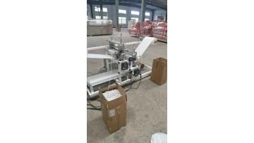 Nonwoven elastic glove machine