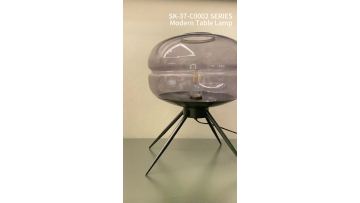 Three-legged cylindrical glass table lamp