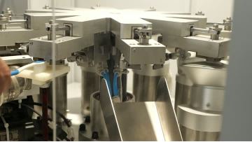 Toothbrush bristle end-rounding machine