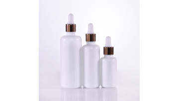Round glass bottle with dark brown caps