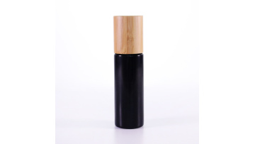 Black glass sprayer bottle with bamboo lid