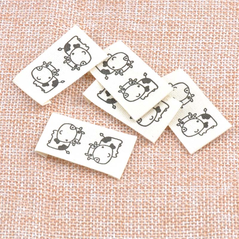 50pcs Beige Woven Labels For Clothing Care Labels Cartoon Cow Woven Labels Clothing Shoes Bags Washable Garment Tags CP1528