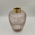 Tall glass vase with ribbed pattern