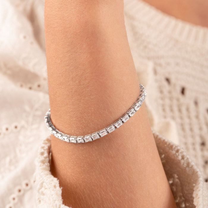 White-tone and yellow-tone emerald-cut lab-grown diamond tennis bracelets worn together