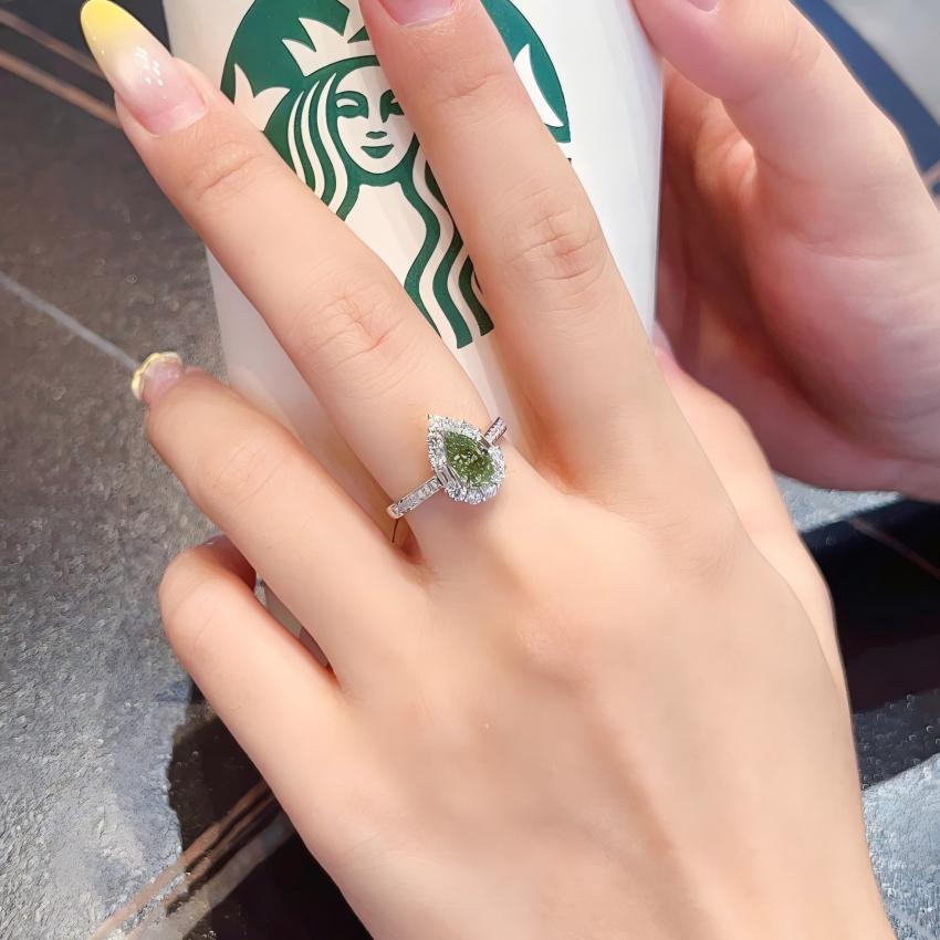 Fancy Vivid Green pear lab diamond mixed cut halo ring shown on hand