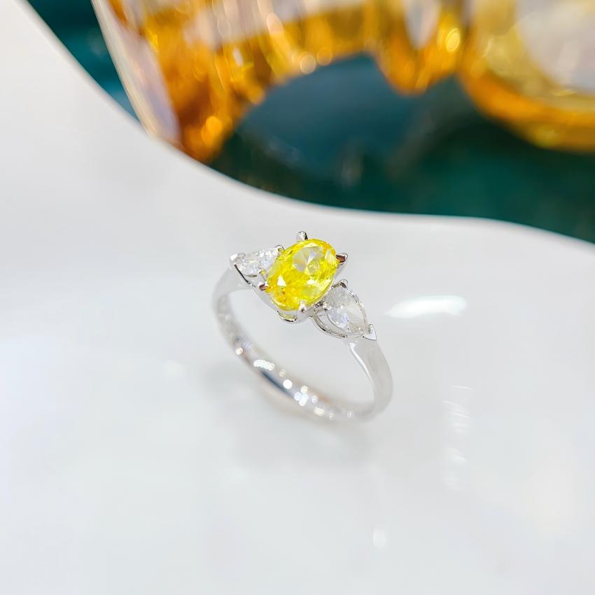 0.71 carat oval yellow lab diamond ring with pear shaped side stones