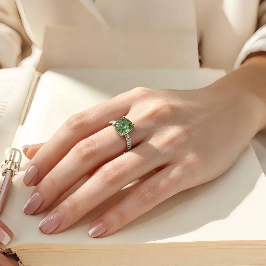 Green cushion lab diamond pave shoulder ring shown on hand