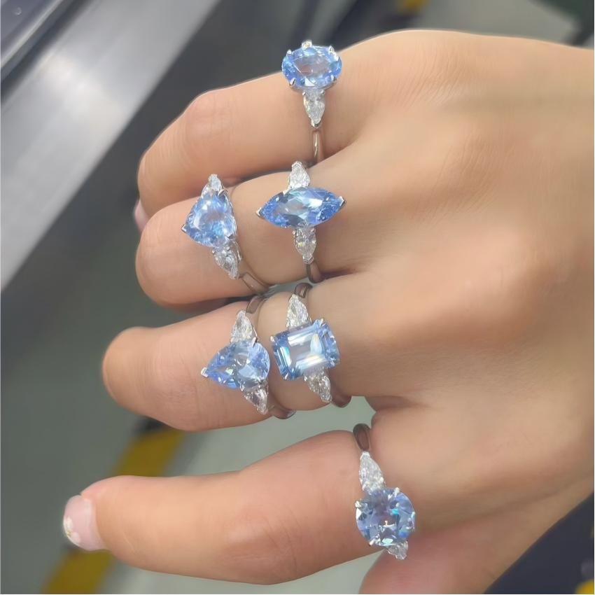 Multiple fancy shape blue lab diamond rings with matched pear side diamonds shown on hand