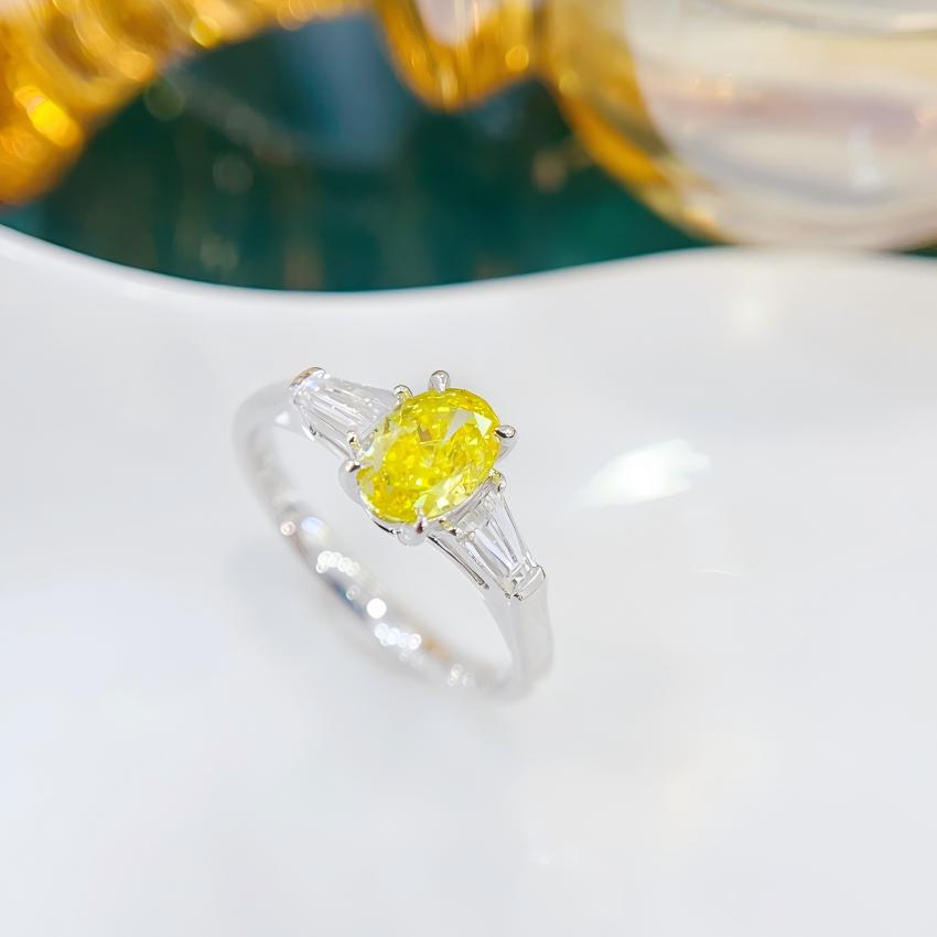 0.50 carat yellow oval lab diamond ring with large tapered baguette side stones