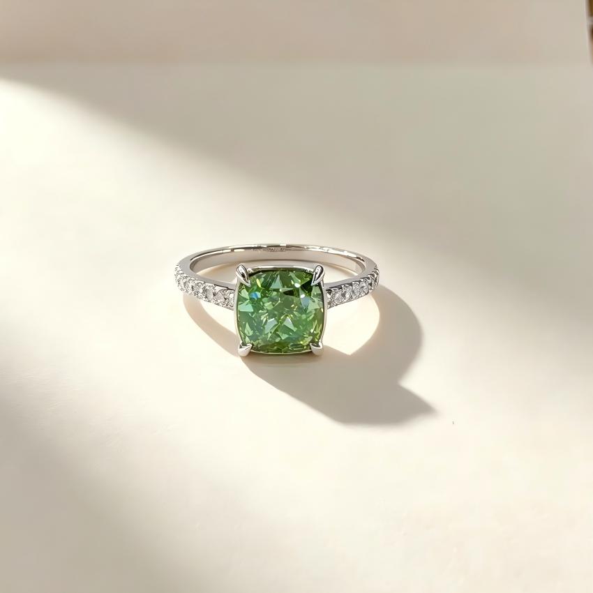 2.01 carat green cushion lab diamond ring with four claws and pave shoulders