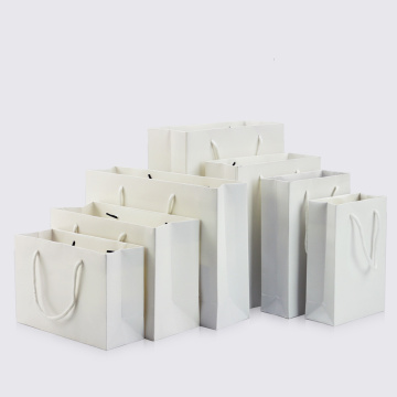 10pcs / white portable paper bag holiday packaging gift storage clothing shopping bag support printing 1 color simple logo