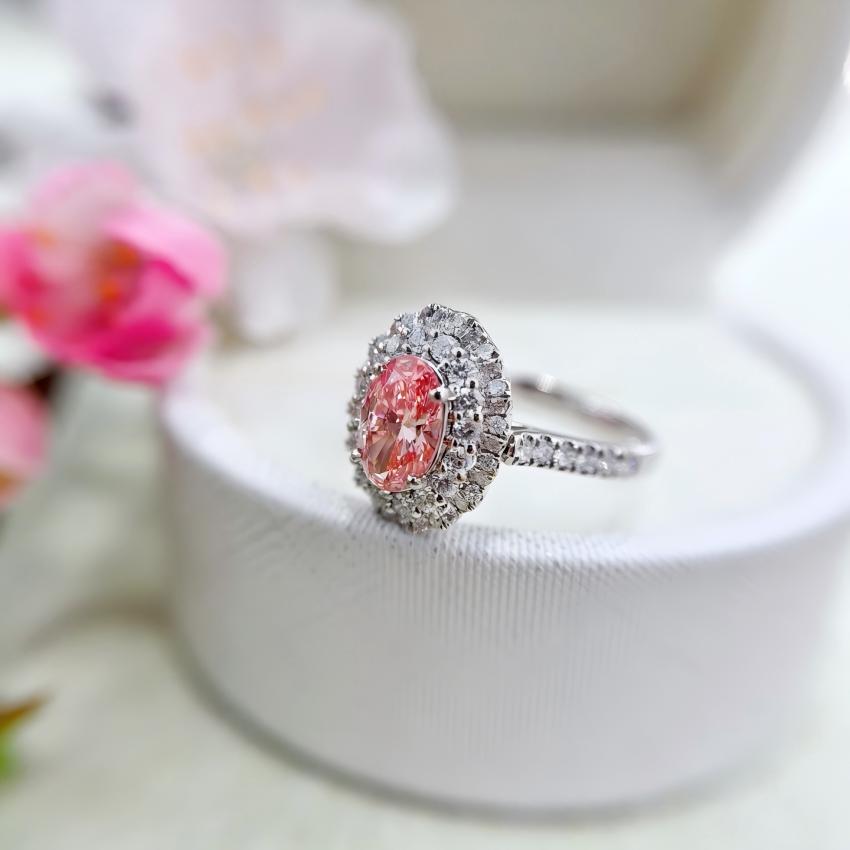 Side profile of a detachable oval pink diamond halo ring with pavé band