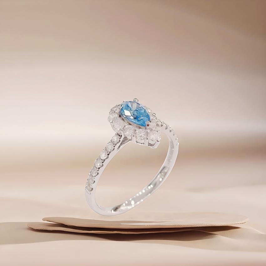 Side angle petite teardrop blue halo ring with slim pavé shank