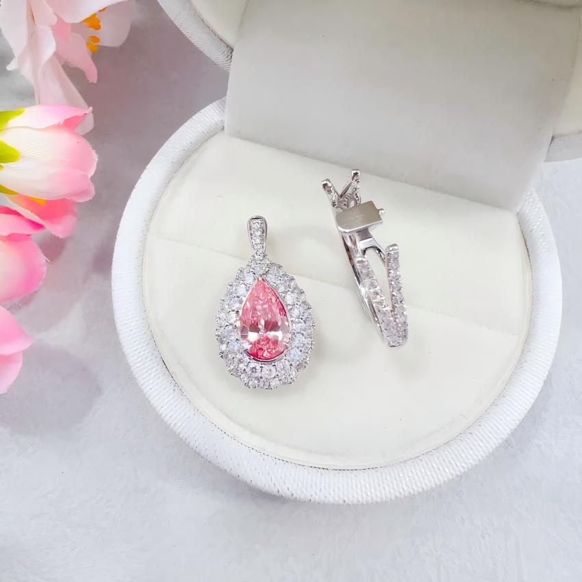 Side view of a pear pink lab diamond ring with raised halo setting and split shank
