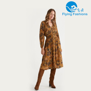 A brownish-yellow V-neck patterned dress