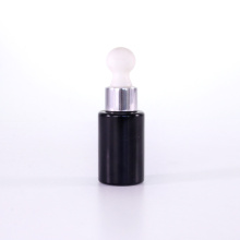 Black essential oil bottles with white rubber bulb