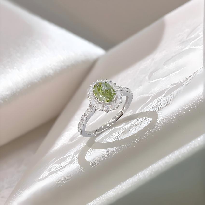 Angled view of Fancy Vivid Green oval lab diamond halo ring showing halo height and pave shoulders