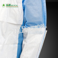 Disposable sugical gown material with reinforced piece