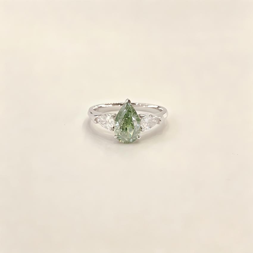 Fancy Vivid Green pear lab diamond three stone ring with twin pear side diamonds in 18K white gold
